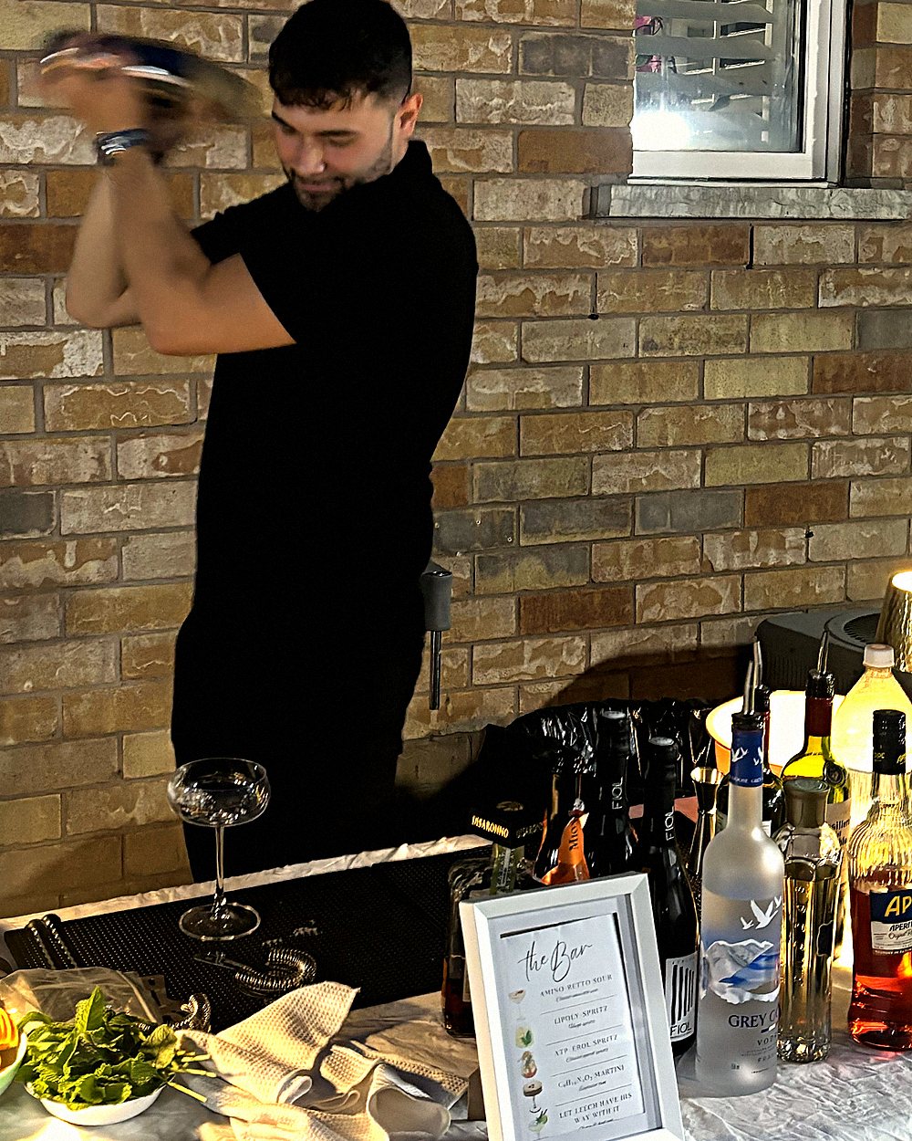 Bartender shaking a cocktail behind the bar